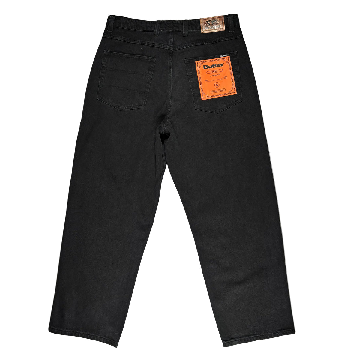 Black denim jeans shown from the back, laid flat on a white surface. The orange Butter brand tag is visible in the back pocket.