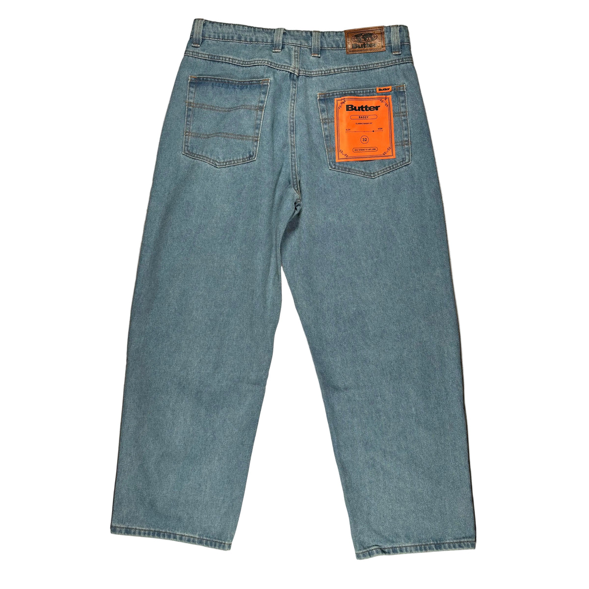 Light blue denim jeans shown from the back, laid flat on a white background. The back pocket has an orange Butter brand tag, and a leather patch is visible at the waistband.