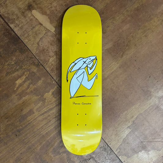 yellow skateboard deck with hand drawn tasteful character doing a small bow