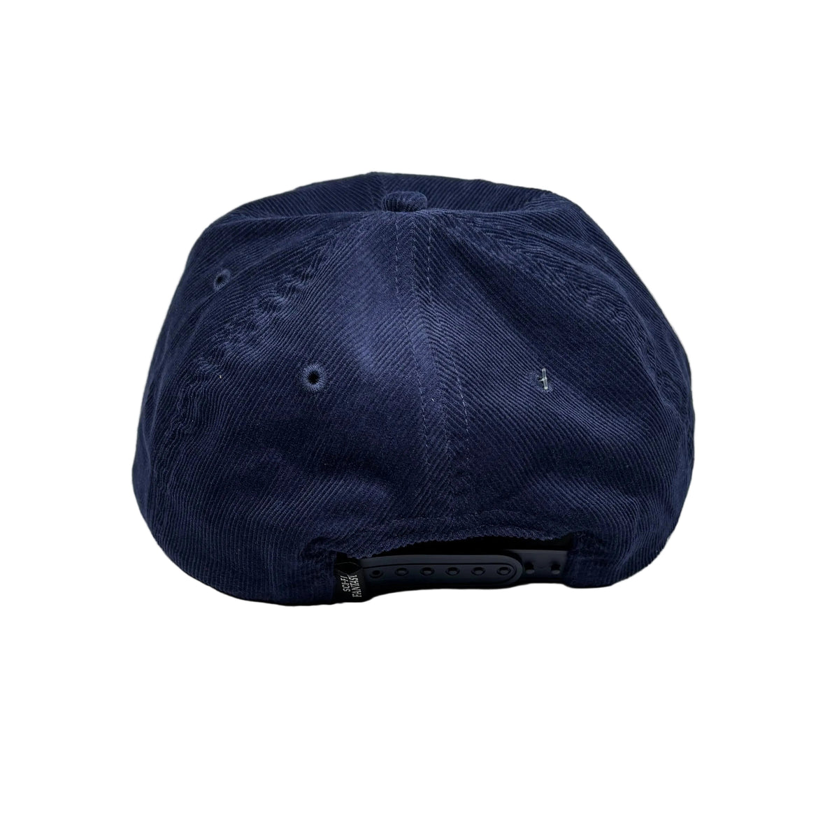A dark navy blue structured baseball cap viewed from the back, resting on a white surface.