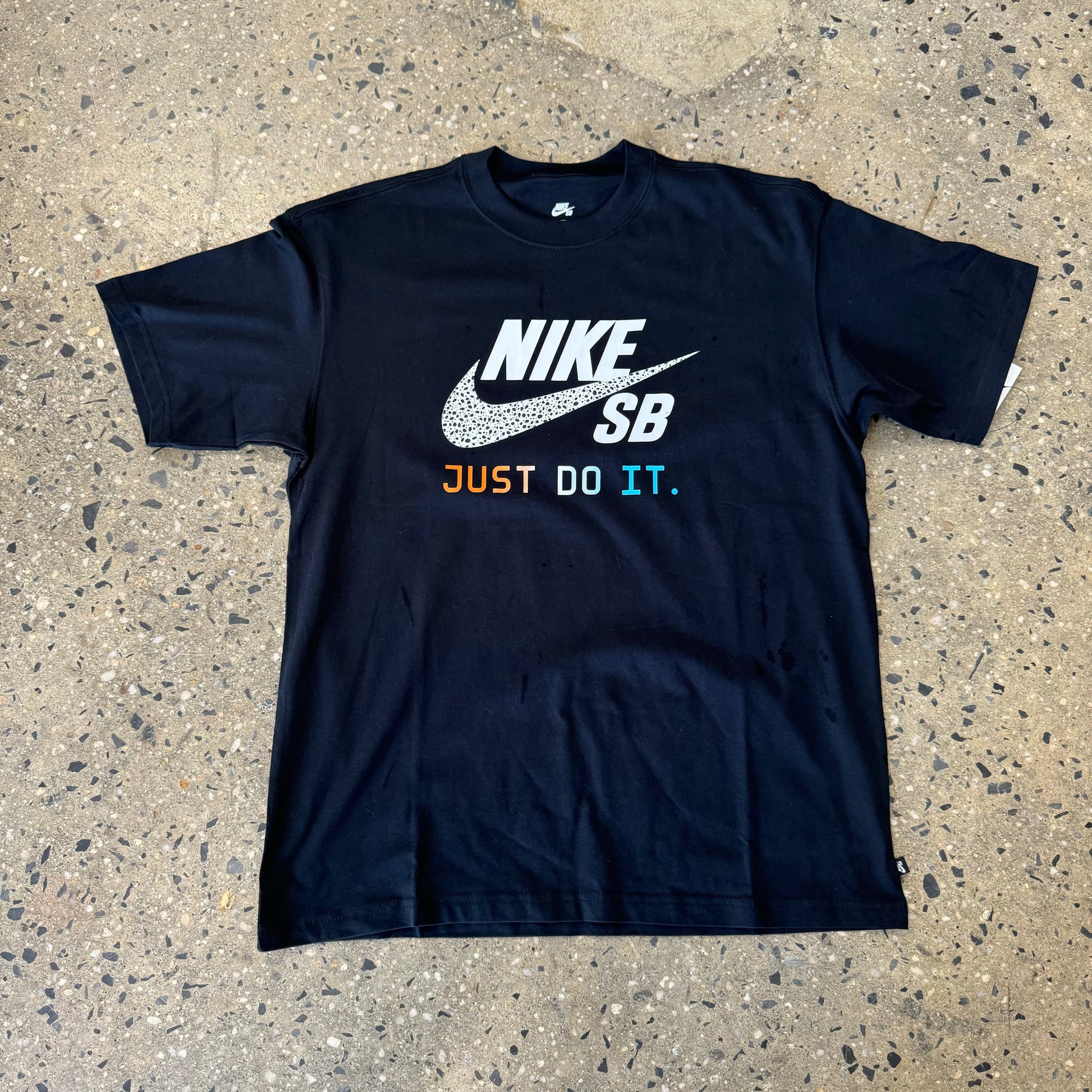 black NIKE SB t-shirt with white and multi color text