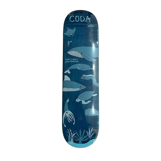 A Coda skateboard deck featuring a blue ocean-themed graphic with illustrations of sharks, whales, a jellyfish, and the text 'hullo crocodile jake wether' on a white backgroud