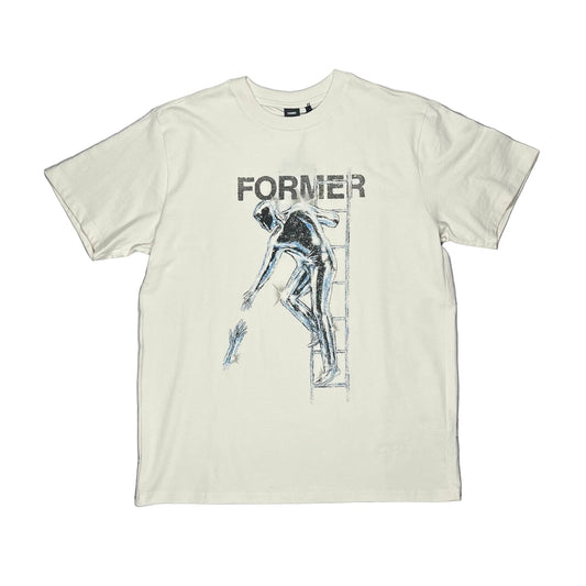 An off-white short-sleeve graphic t-shirt laid flat on a white surface. The shirt features a dark graphic print of a figure climbing a ladder with the word 'FORMER' printed above it.