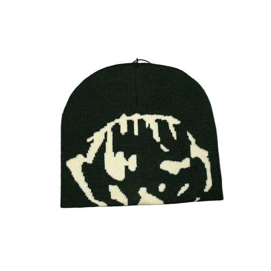 A dark green knit beanie with a cream-colored stylized tiger face pattern, laid flat on a white background.
