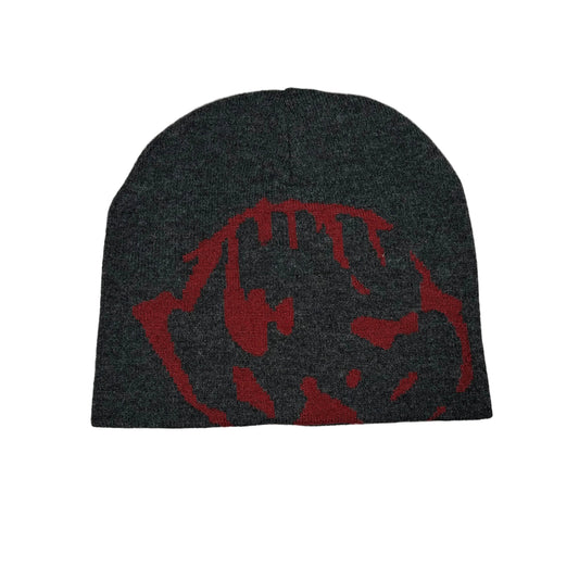A dark charcoal gray wool beanie with a red stylized graphic on the front, displayed flat against a white background