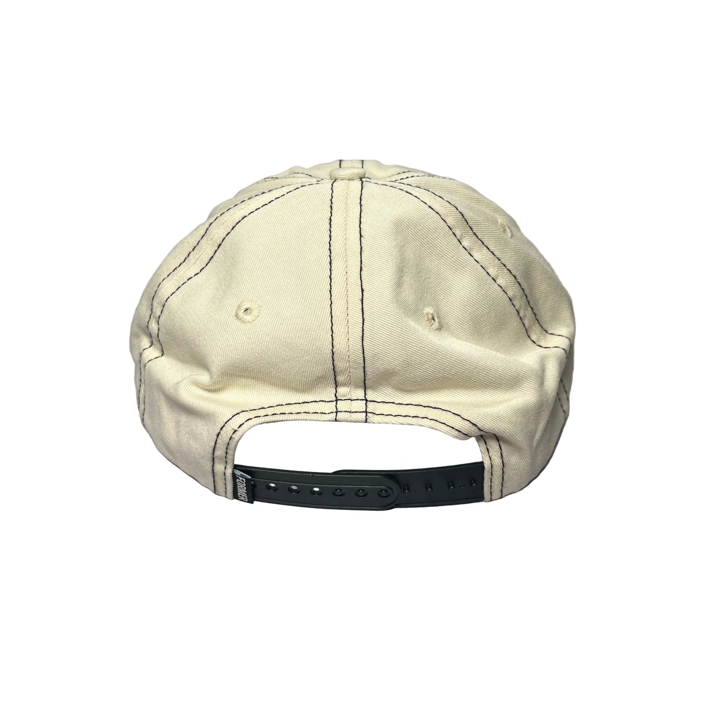 A cream-colored cotton baseball cap viewed from the back, resting on a textured gray surface. The cap features dark contrast stitching and a black plastic snapback closure.