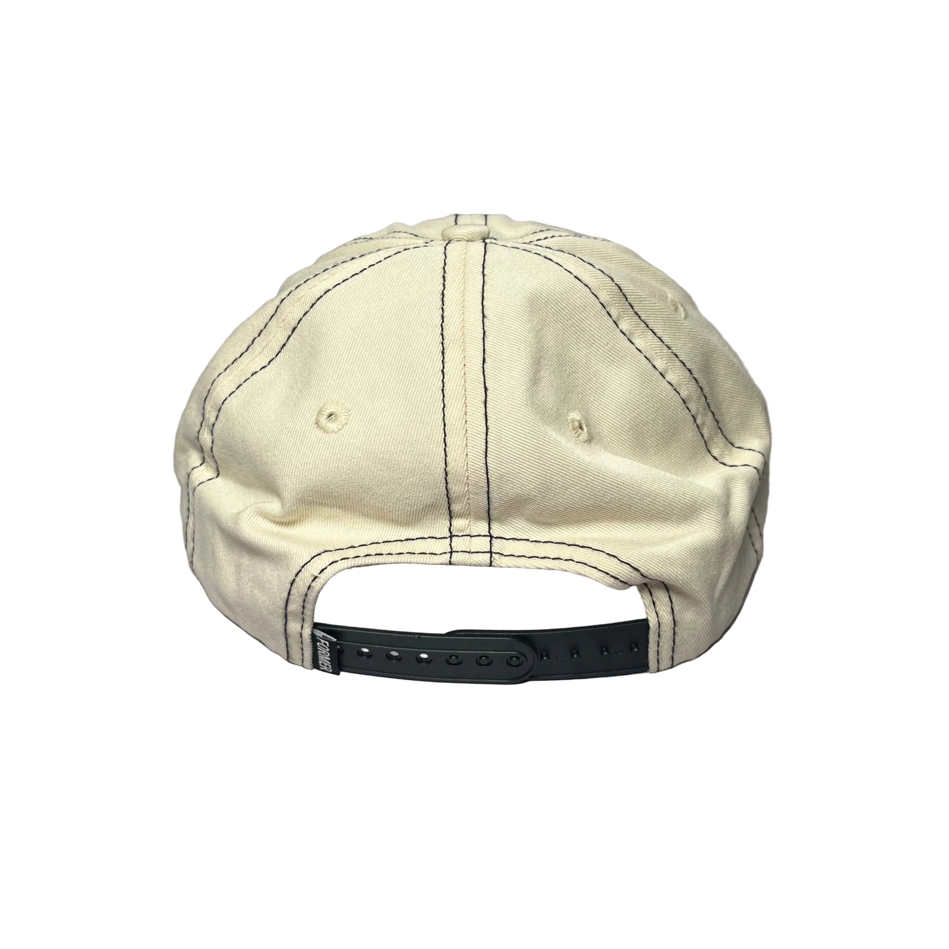 A cream-colored cotton baseball cap viewed from the back, resting on a textured gray surface. The cap features dark contrast stitching and a black plastic snapback closure.