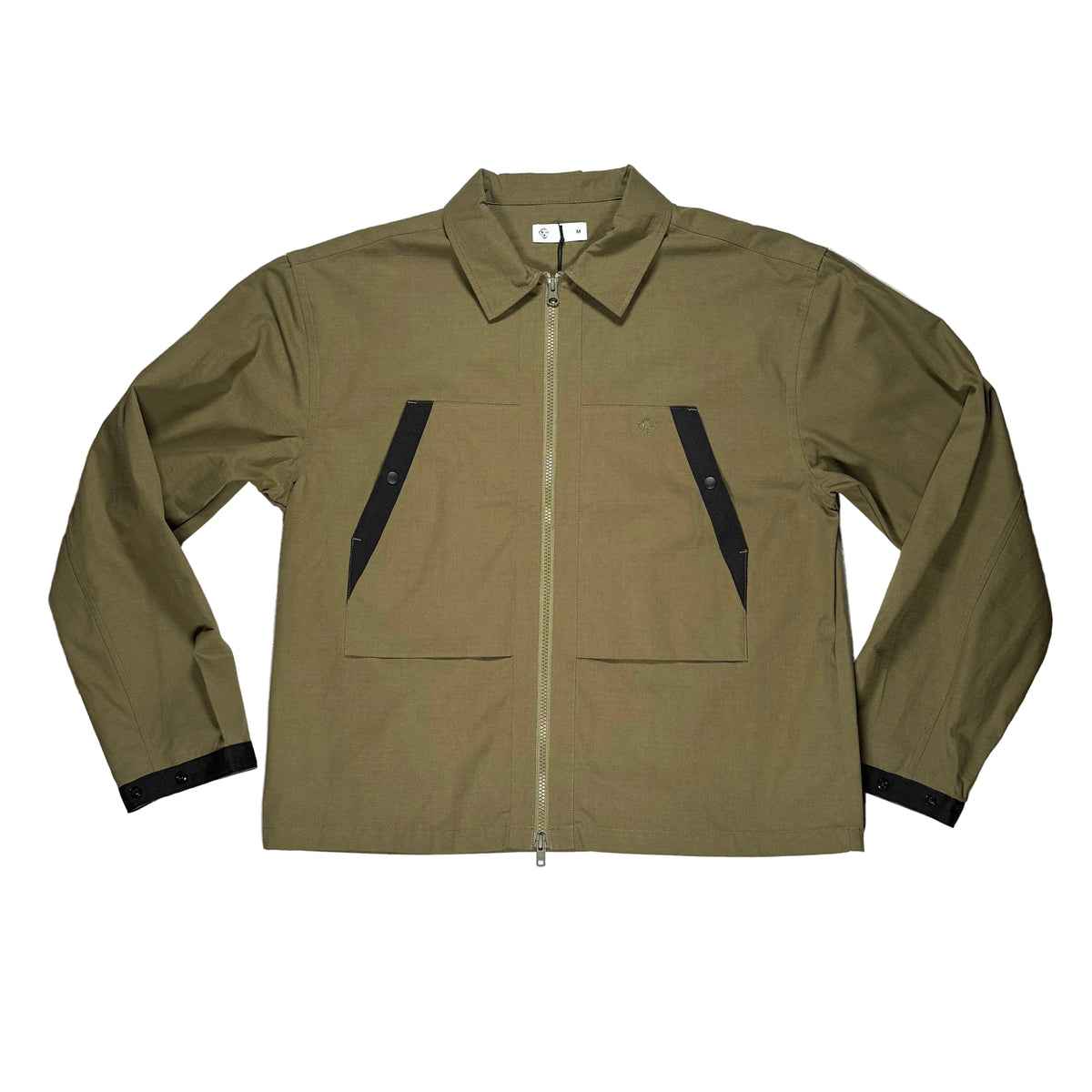 An olive green utility shirt with black contrast panels on the chest and cuffs, laid flat on a white surface 