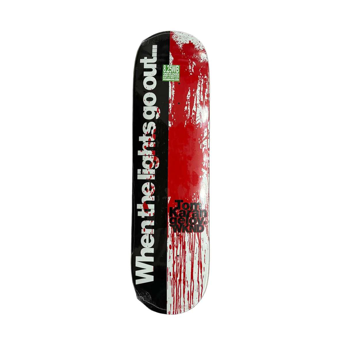 A skateboard deck featuring a graphic design split vertically into black and red sections with white text reading 'When the lights go out.