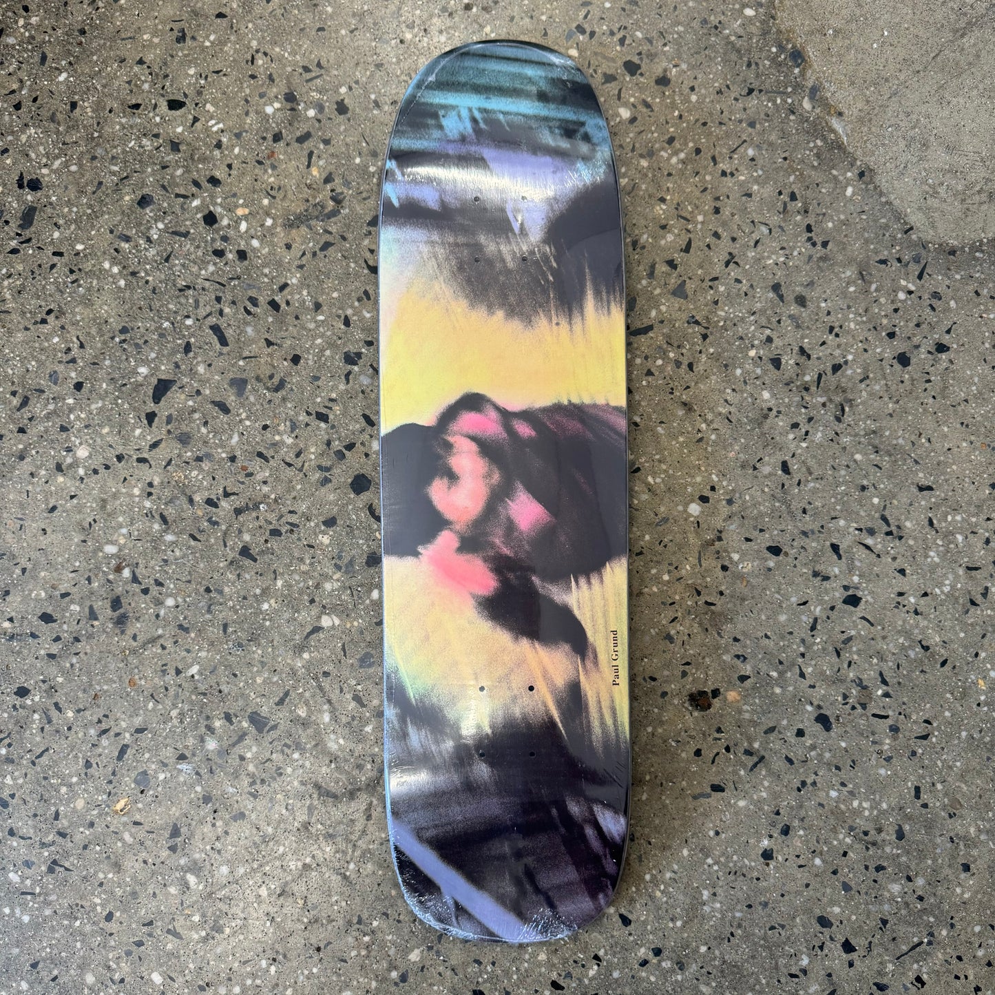 multicolored skateboard deck with a blurry image of a child