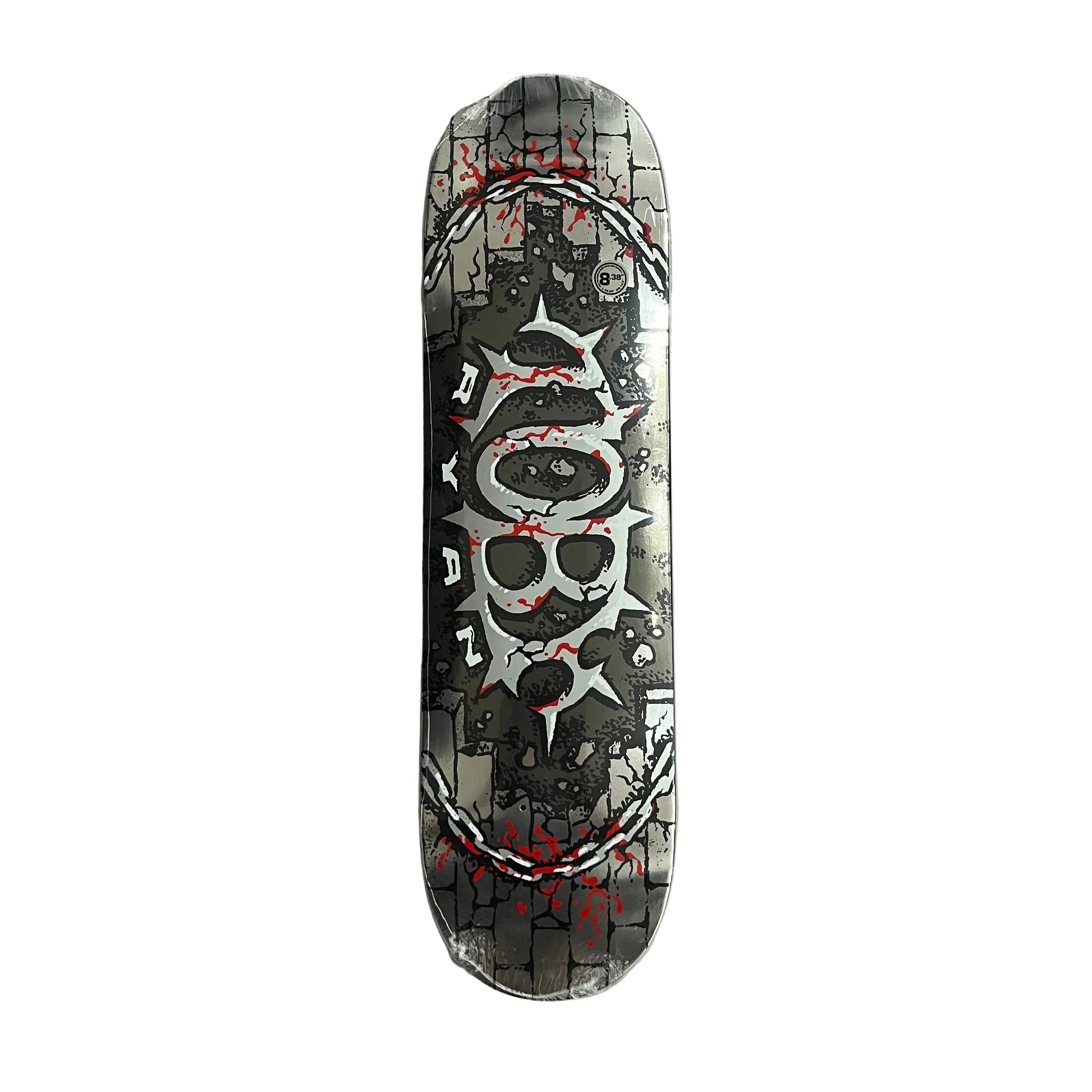 A skateboard deck with a detailed graphic design featuring a central skull motif, cracked black lines, and red splatter accents, photographed flat on a white surface.