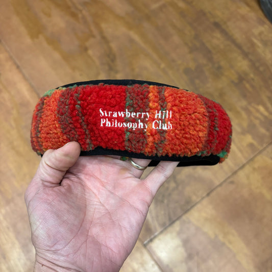 Strawberry Hill Philosophy club embroidered on front of multi color polar fleece headband