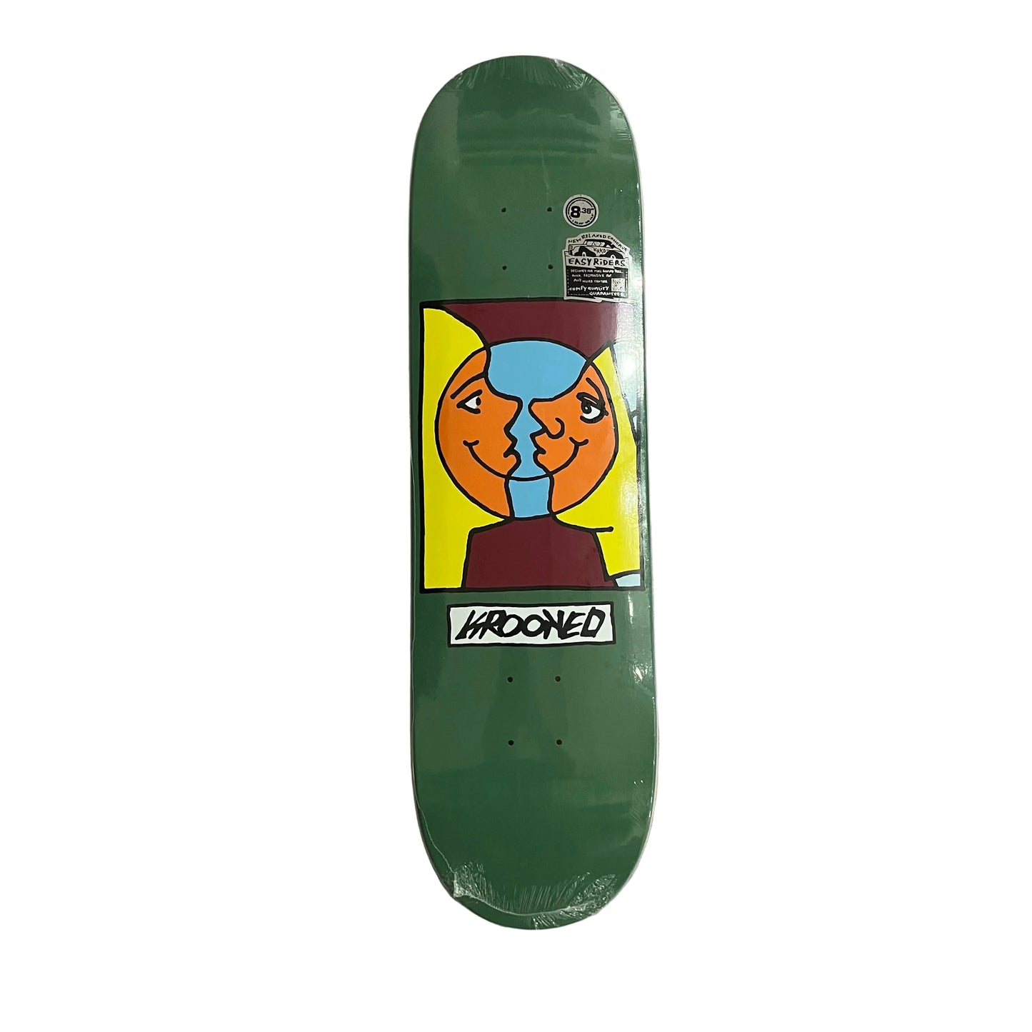 A green skateboard deck with a colorful graphic of two faces kissing, featuring the brand name 'KROOKED' on the graphic, placed on a white surface.