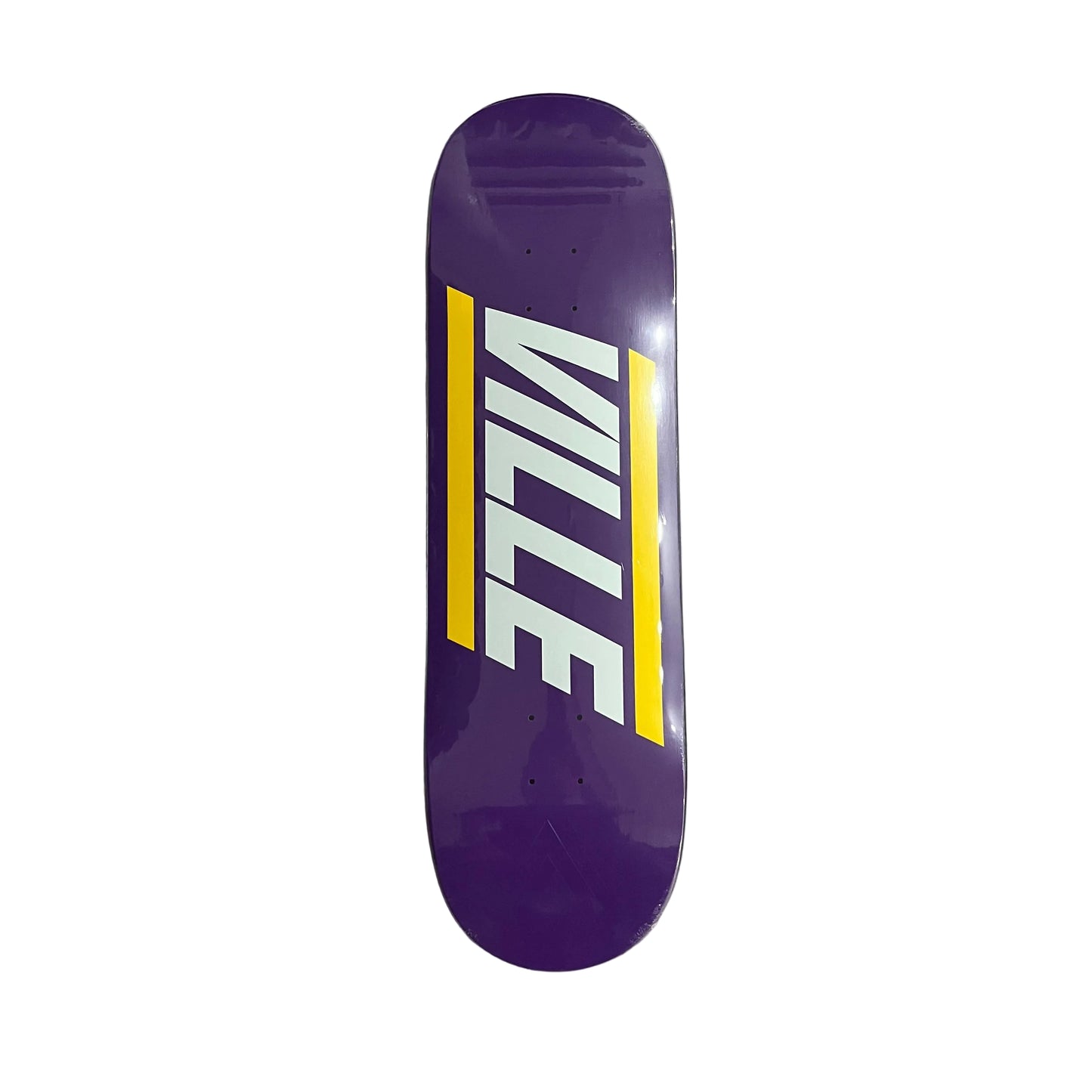 A purple skateboard deck with a bold white and yellow graphic spelling 'VILLE' on a white surface.