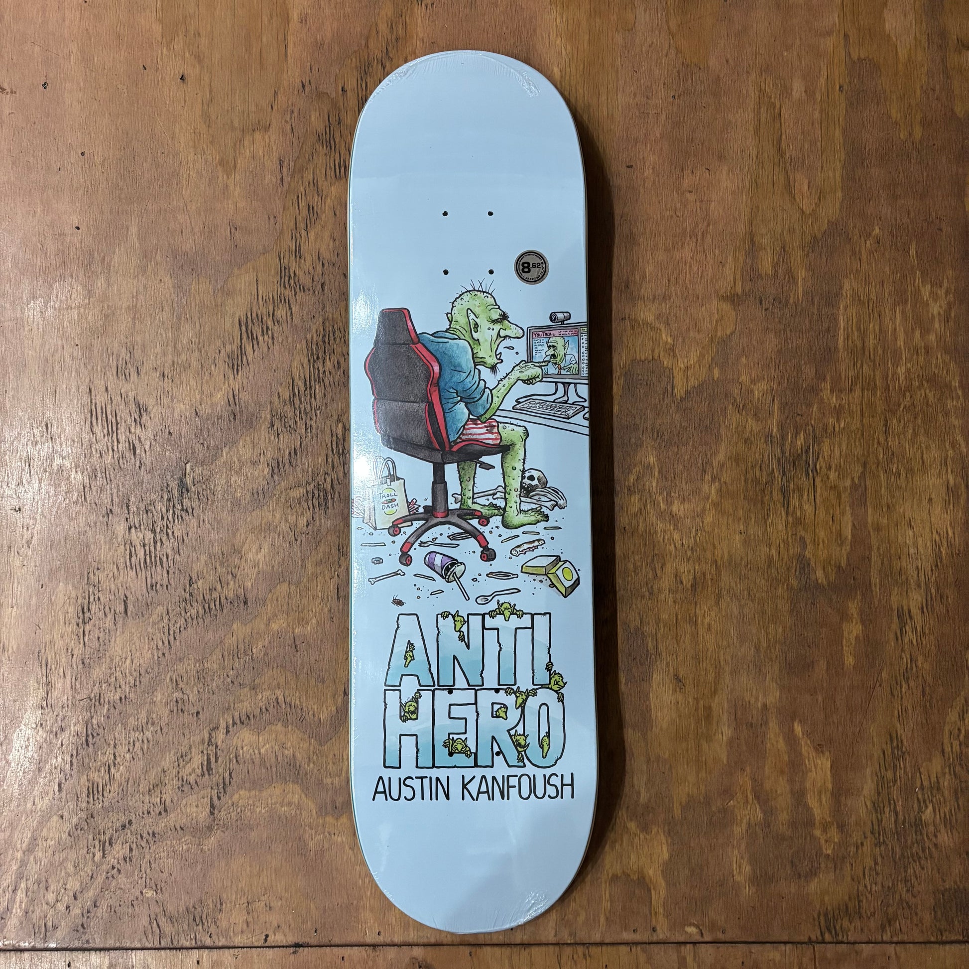 hand drawn logo of troll on computer on bottom of skateboard deck
