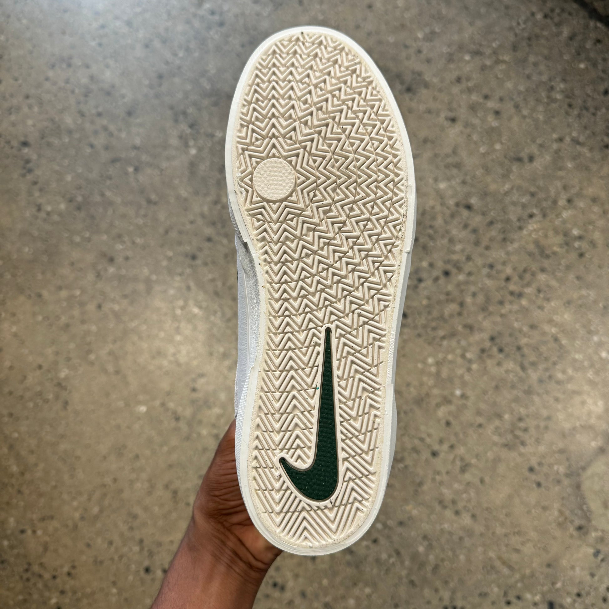 bottom of the shoe. white rubber sole green logo