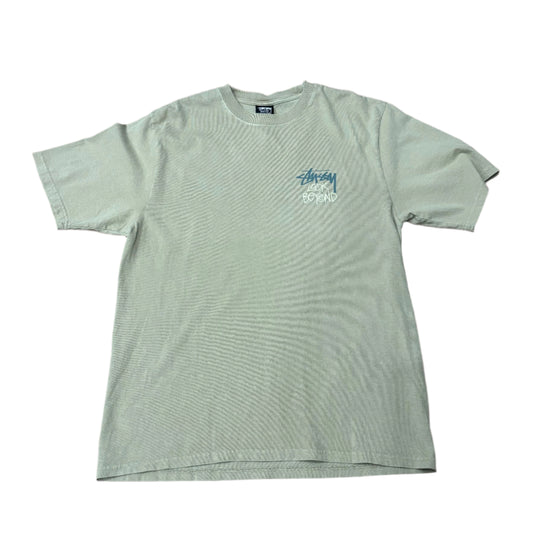 Front view of garment dyed t-shirt with STUSSY LOOK BEYOND screenprinted on left chest