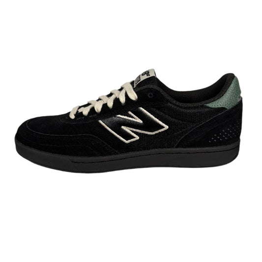 black suede lowtop new balance skate sneaker with white and green accents