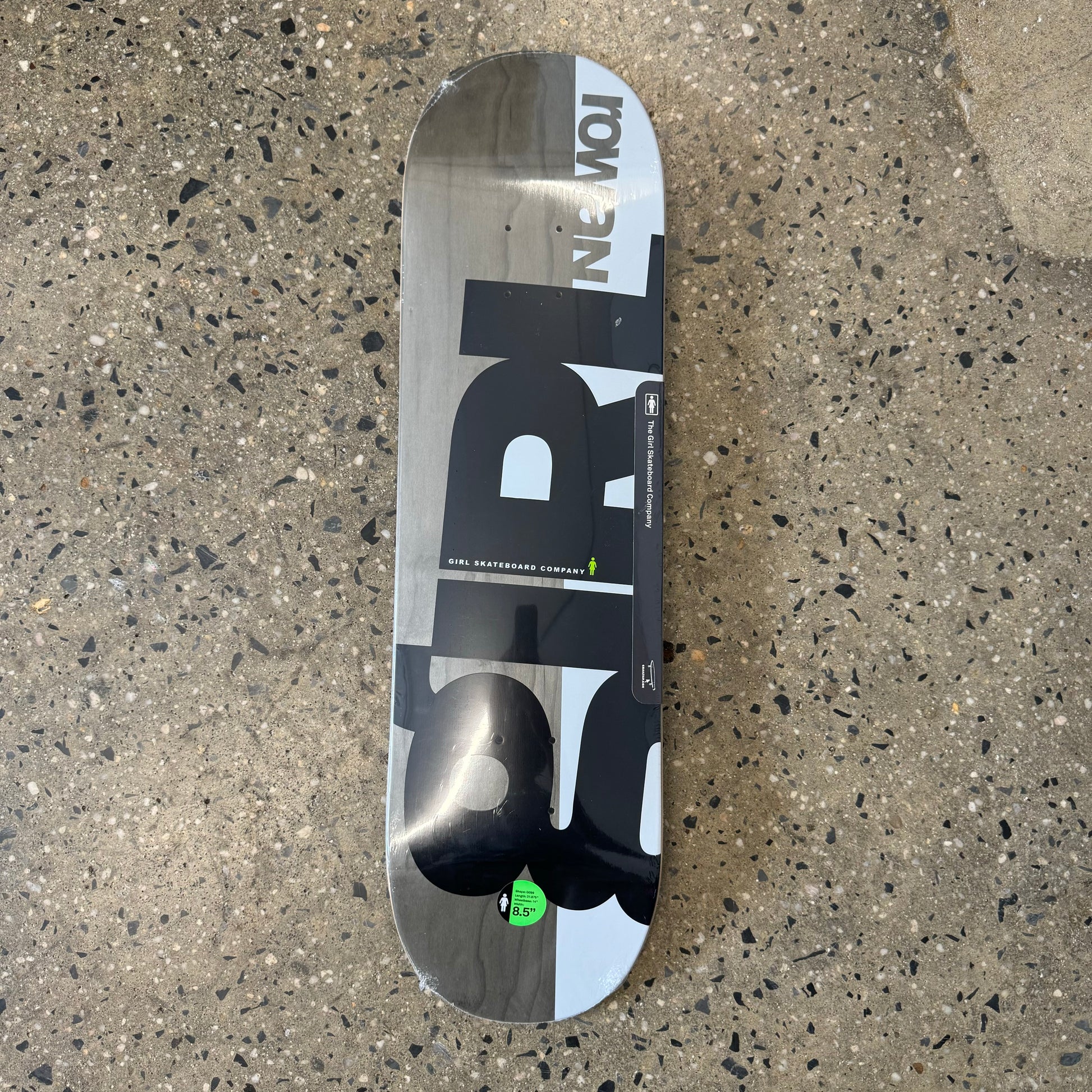 Grey woodgrain skate deck with black Girl logo and white design