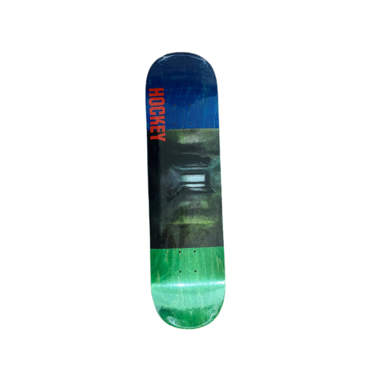 multi color woodgrain skateboard deck and middle graphic of hallway that's scary looking