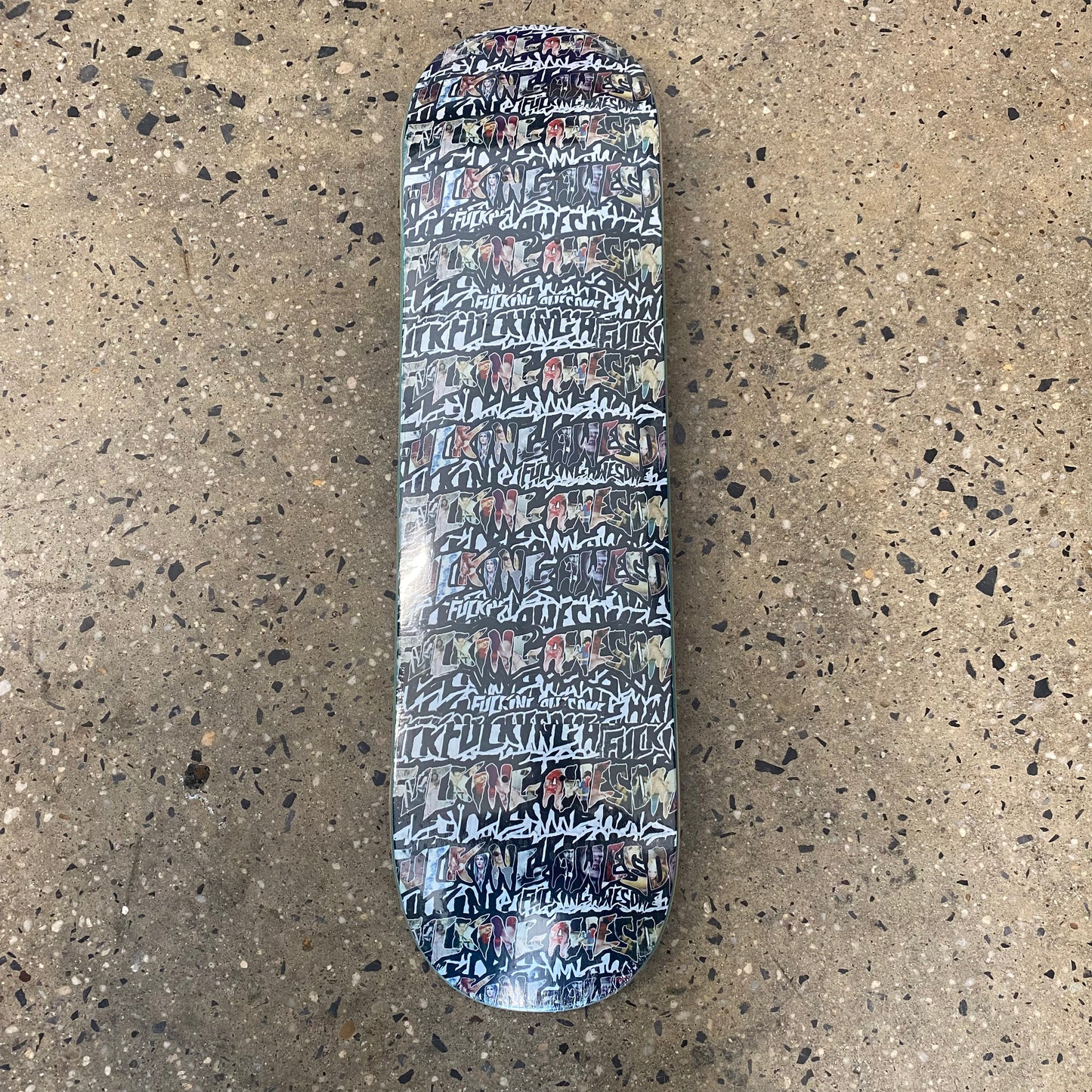 skateboard deck with a collage of fucking awesome stickers