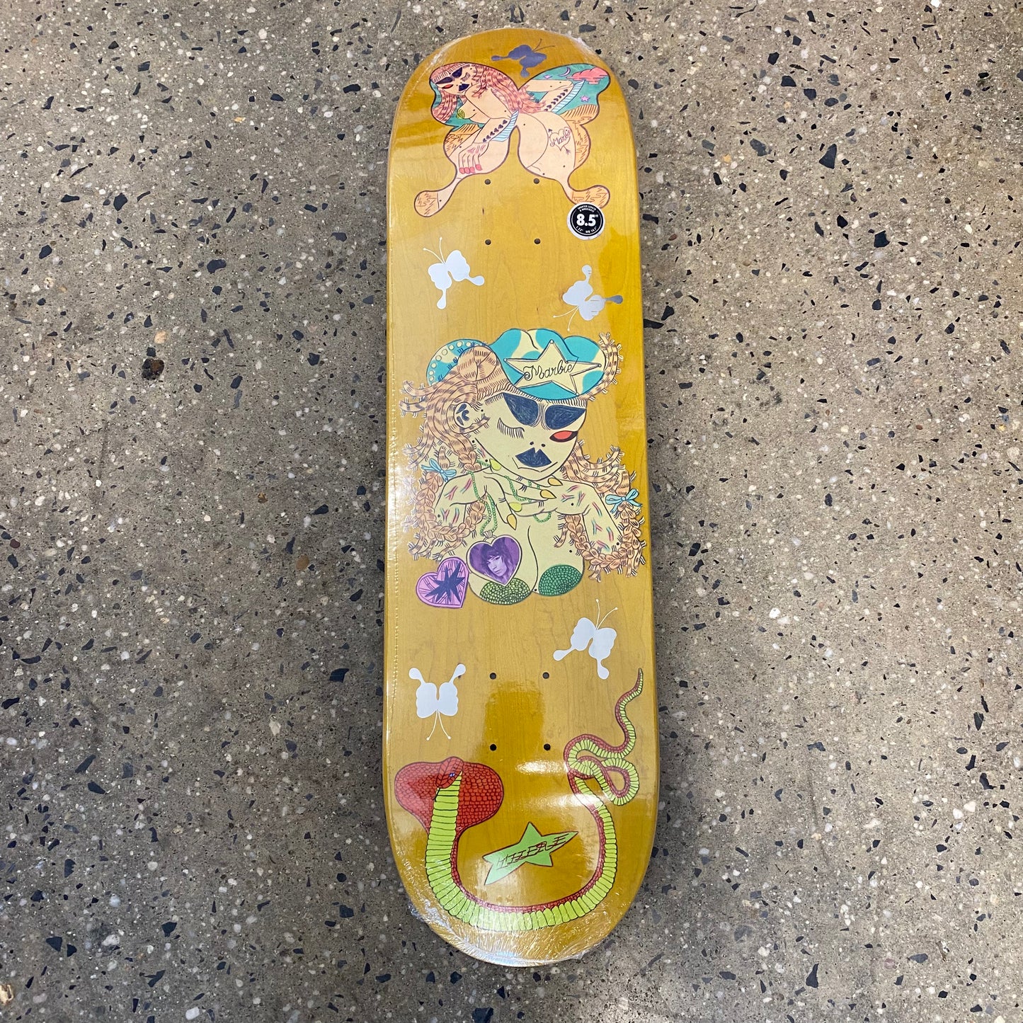 skateboard with assorted doodles of snakes and other characters throughout