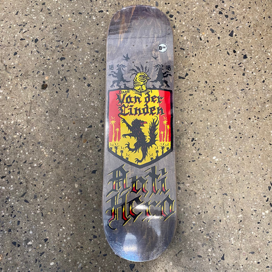 skateboard with a medieval crest with an animal in the middle and black writing