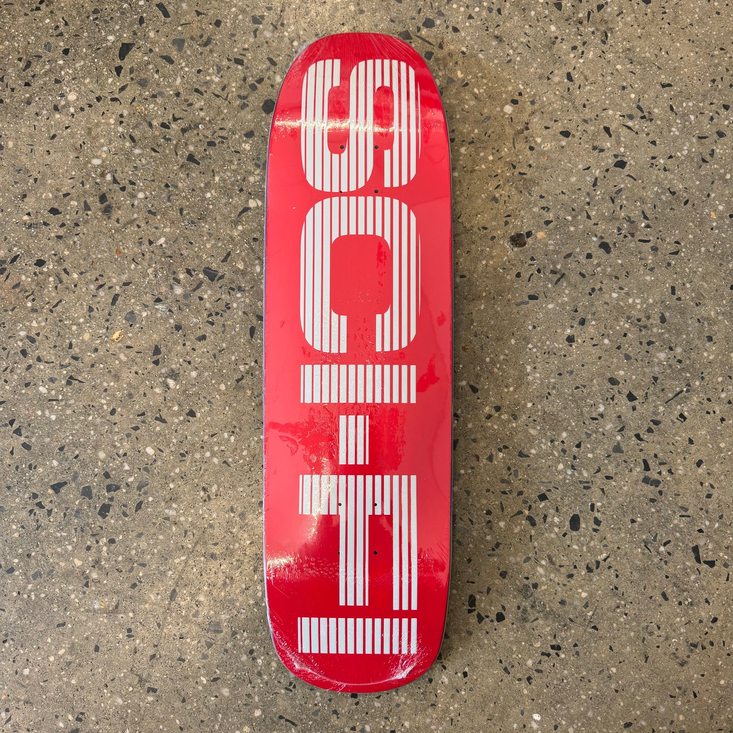 red skateboard deck with big white text