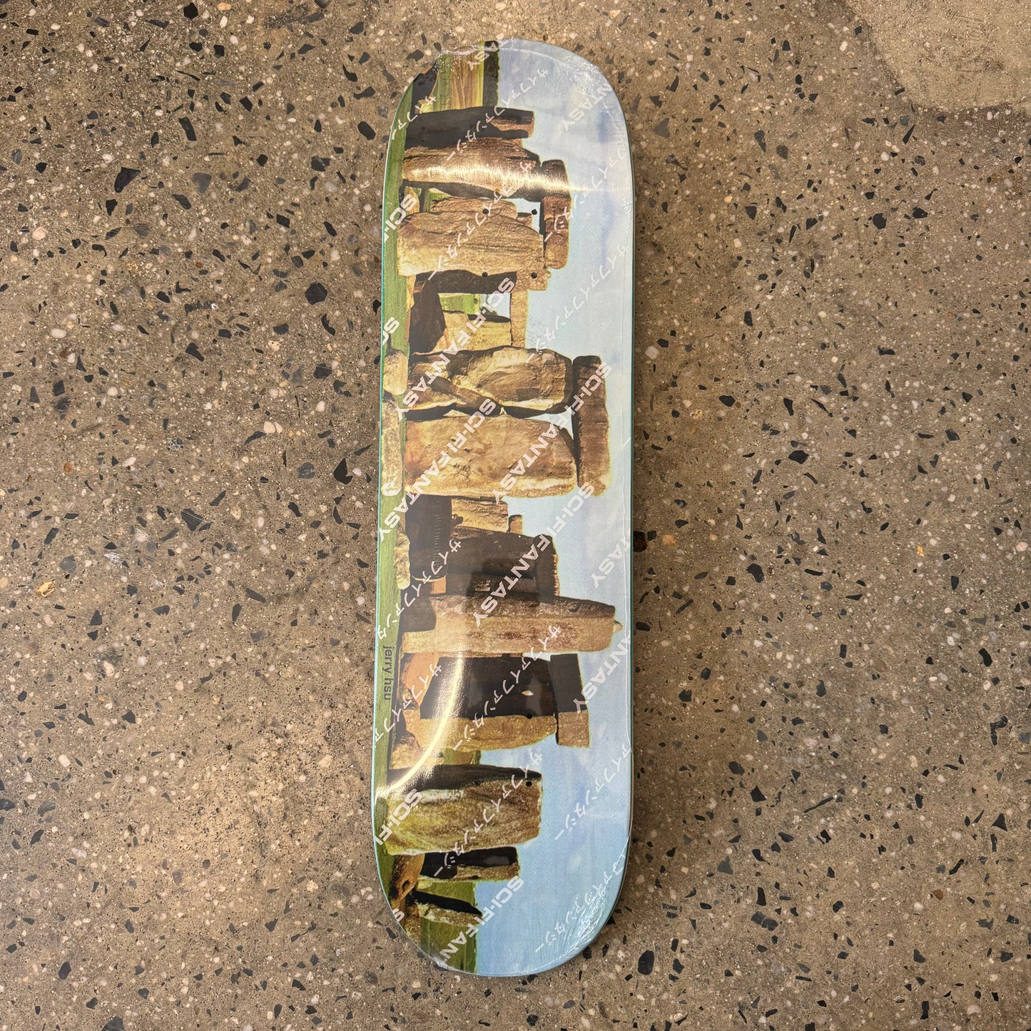 skateboard deck with big house sized stones on it