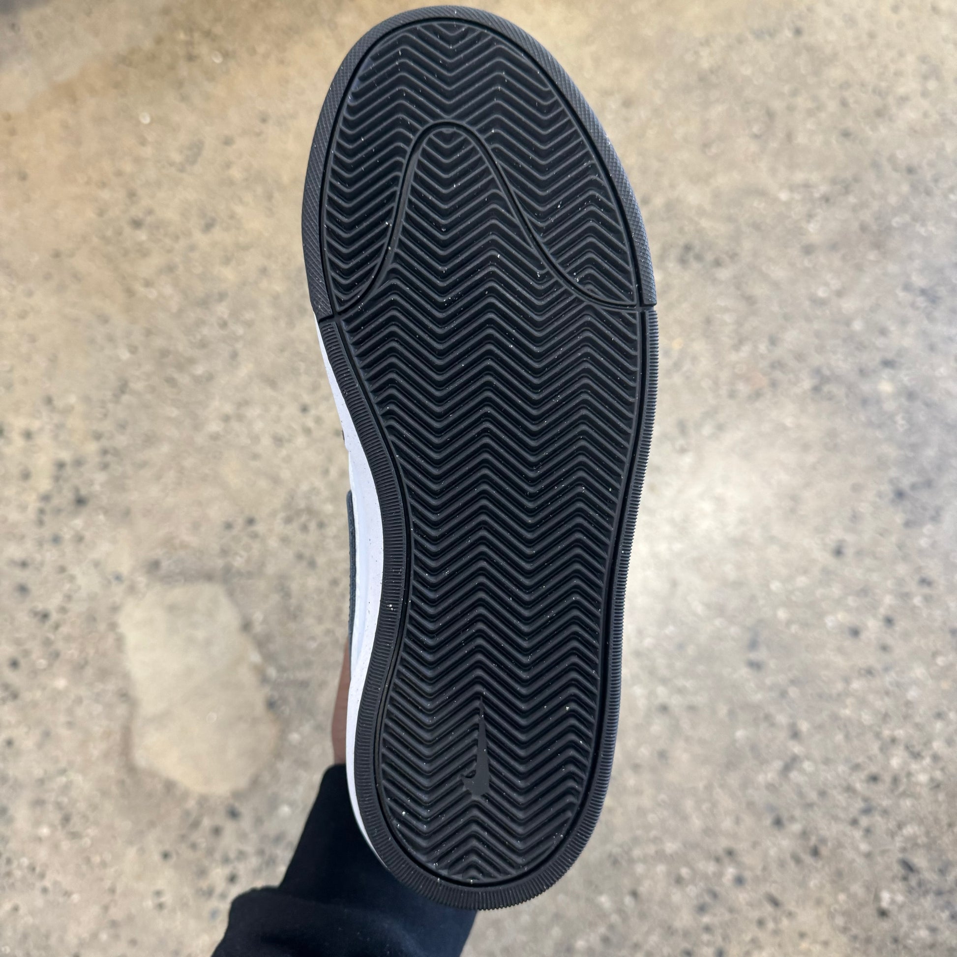 View of bottom of skate sneaker black rubber