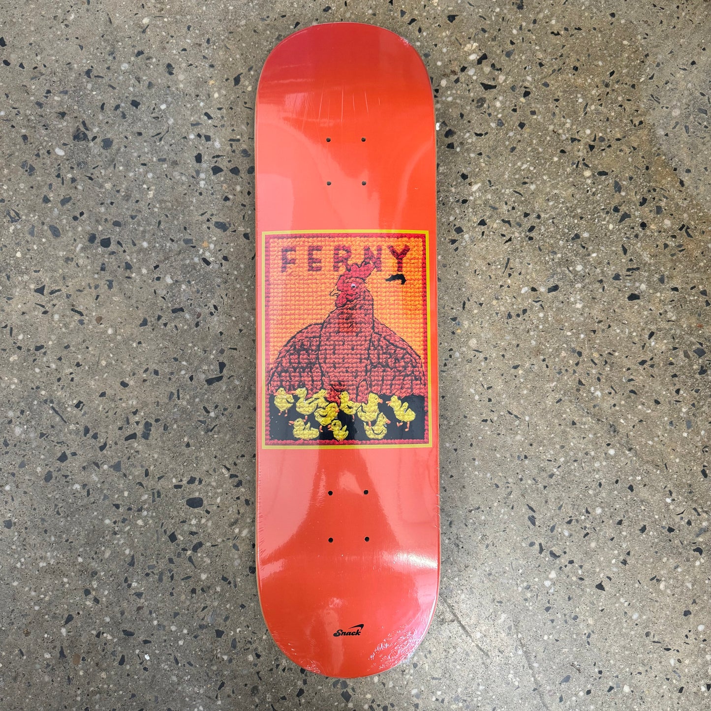 orange skateboard deck with a  multicolored graphic of a hen 