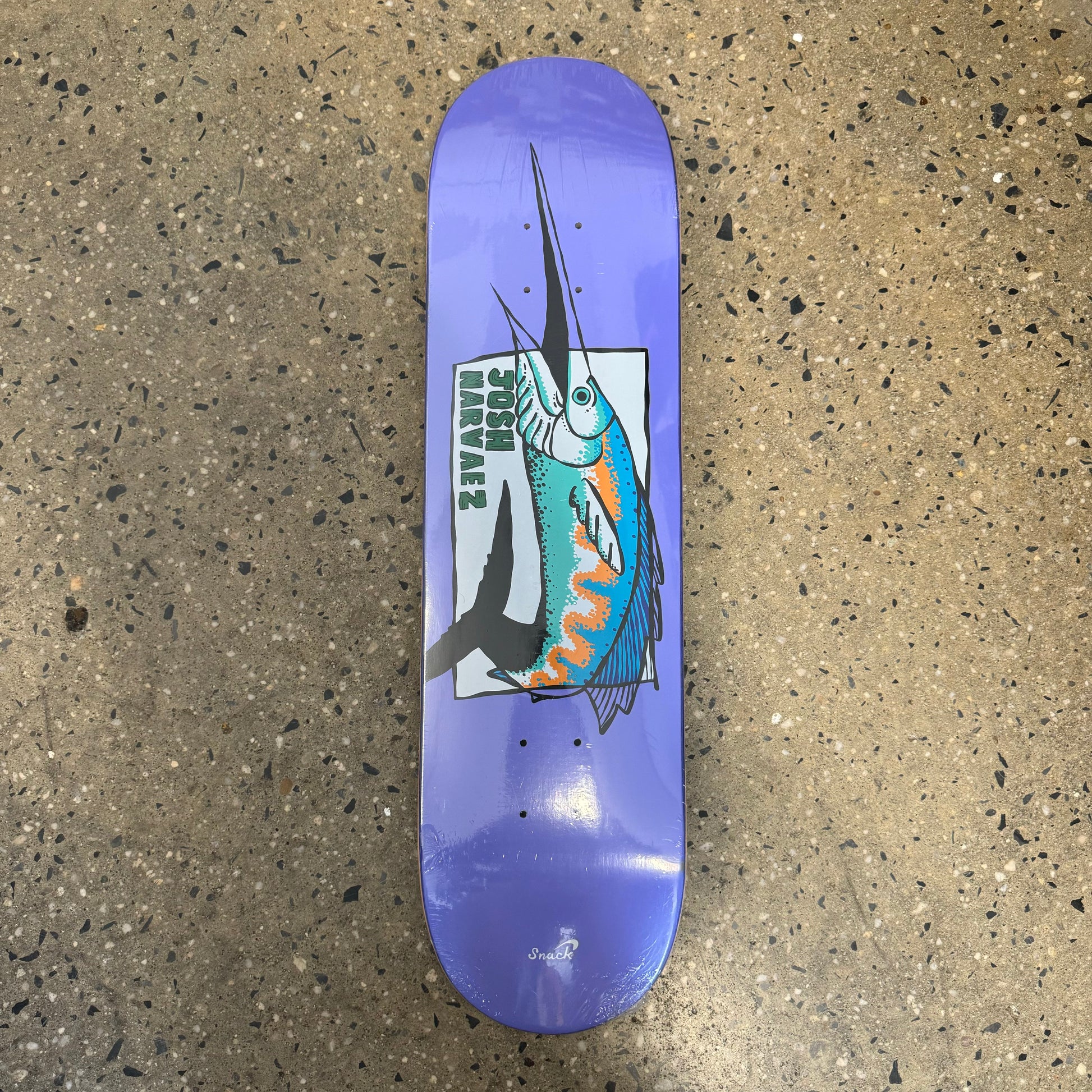 lavender colored skateboard deck with a big fish in the center