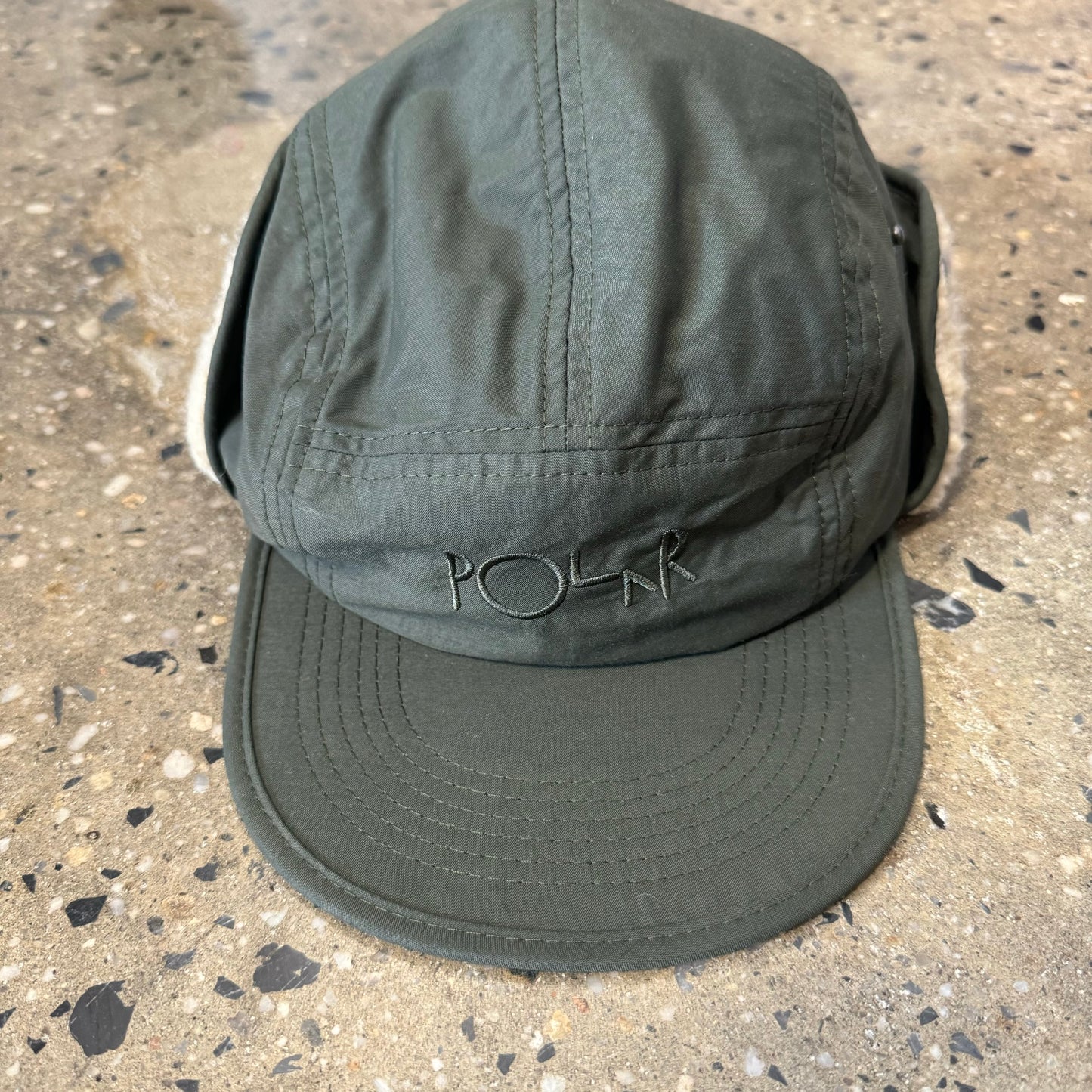 olive green cap with sherpa lined ear flaps