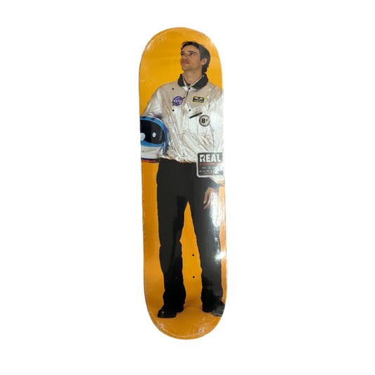 Skateboard deck with a printed design of a person in a space suit on a white surface.