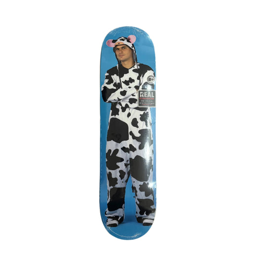 Person wearing a cow costume standing upright, on a skateboard deck
