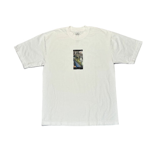 White t-shirt with a small graphic on a white surface