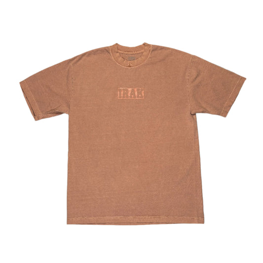 rose colored overdyed t-shirt with a IRAK logo on a white surface