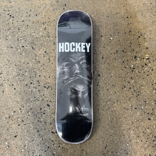 black and grey skateboard deck with ominous art work across the bottom