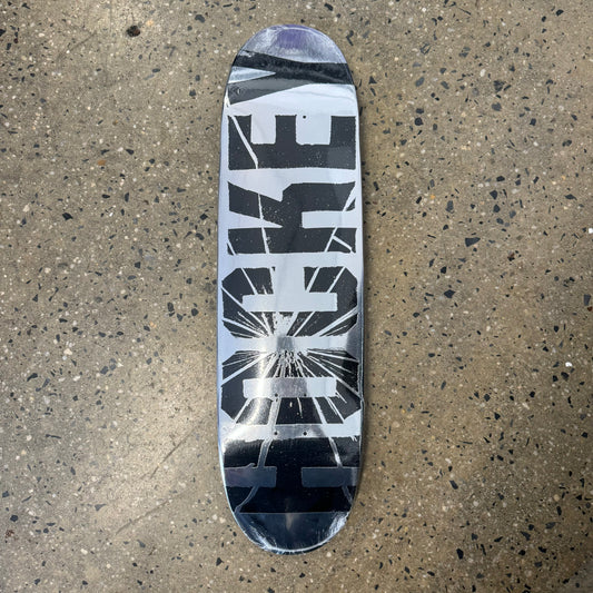 silver foil skateboard deck with big text across the bottom