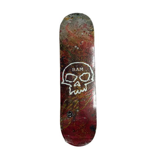 Skateboard deck with a skull logo on a white surface