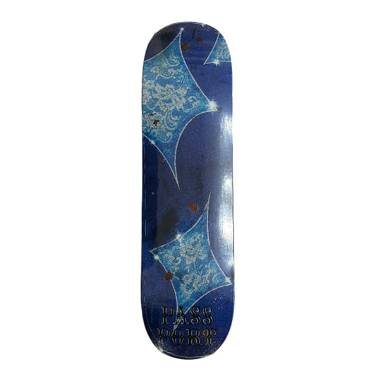 Blue and white patterned skateboard deck on a white surface