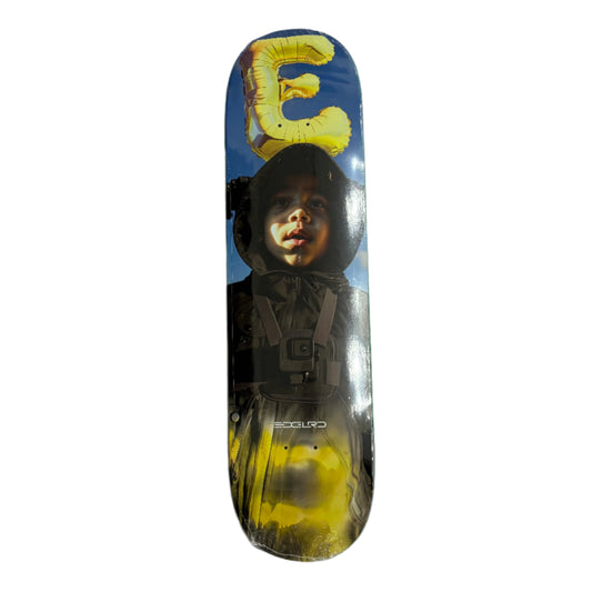 Skateboard deck with a graphic design on a gray surface