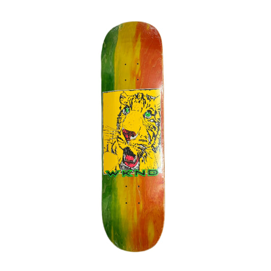 Skateboard deck with a tiger graphic and colorful design on a white surface.