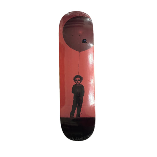 Skateboard deck with a graphic design of a person holding a balloon on a red background