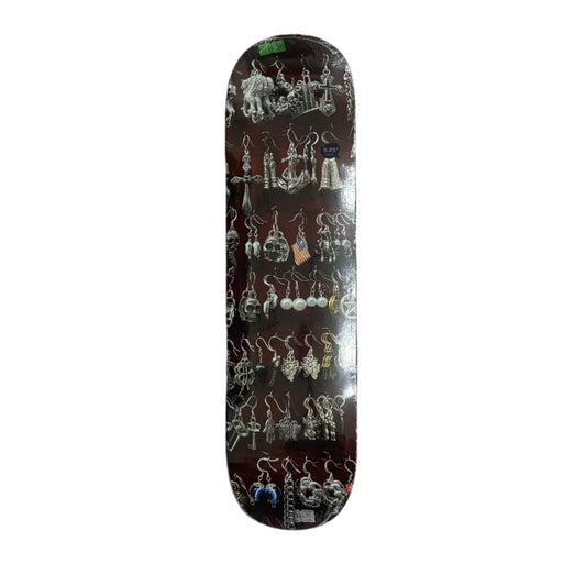 Skateboard deck with assorted earrings display on a white background