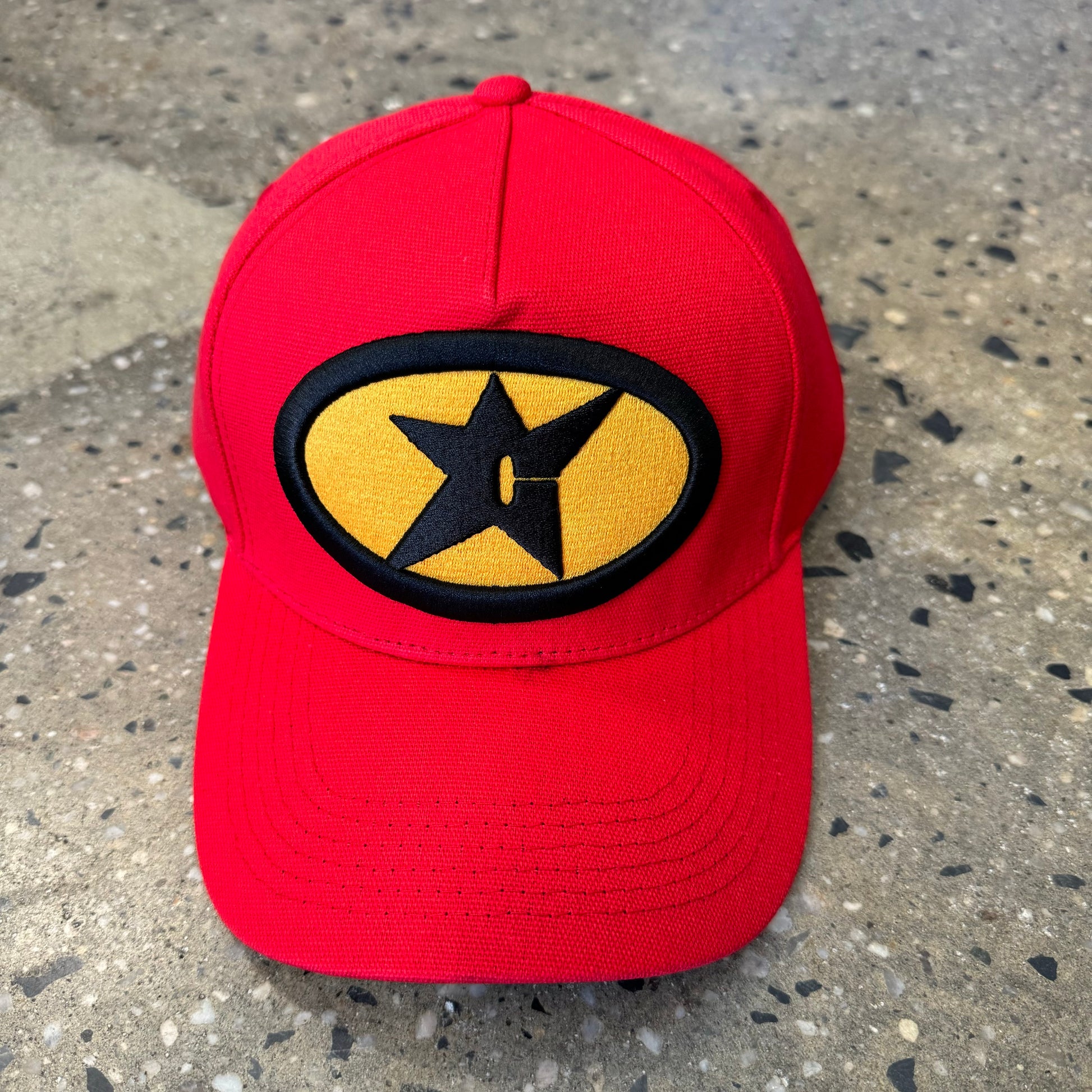 red hat with black and yellow logo in the center