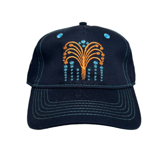 Navy blue cap with embroidered design on a white surface