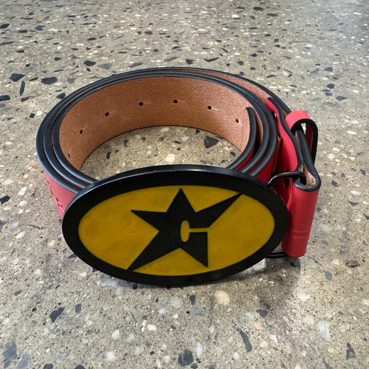 leather belt with black and yellow buckle with a C on the buckle