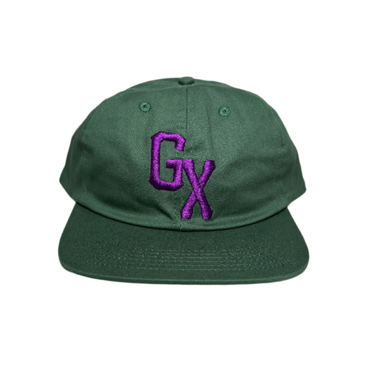 Green cap with a purple logo on a white surface