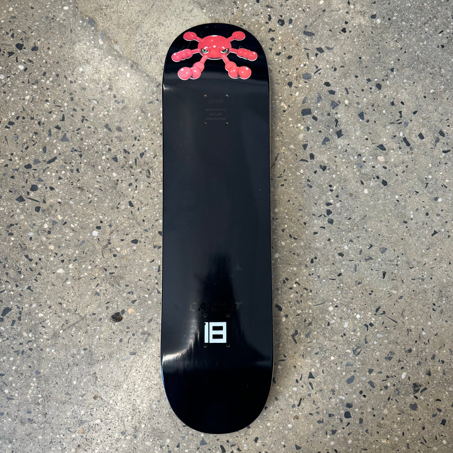 skateboard deck with red character on the nose